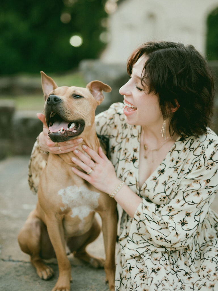 A woman and her dog pose together at their Huntsville pet and owner photoshoot.