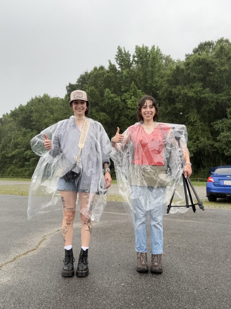 photographer and videographer fauna & film wear clear rain ponchos holding cameras after session