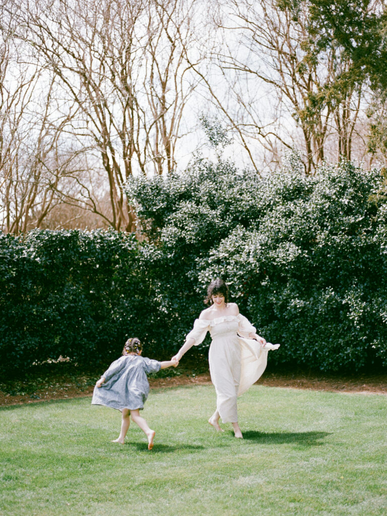 A woman dances with her daughter at their Huntsville motherhood photography session