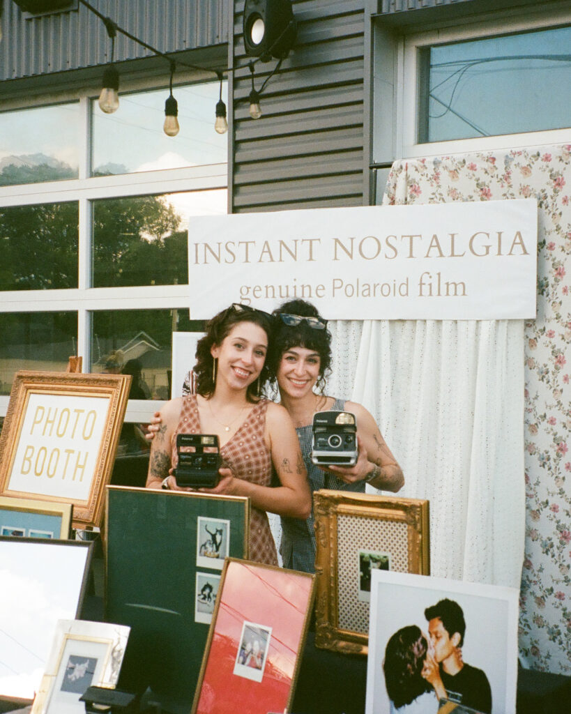 photographers holding polaroid cameras at huntsville photo booth