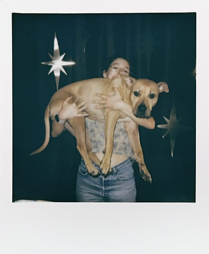 polaroid of a woman holding a cute dog