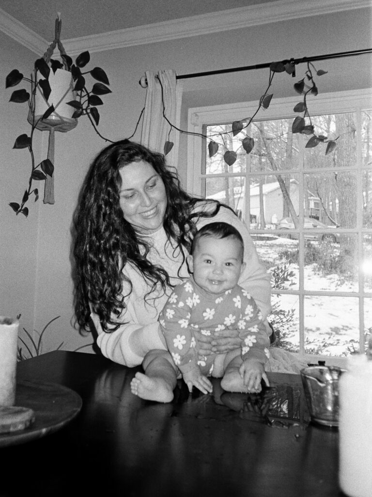 A black and white image of a woman and her baby