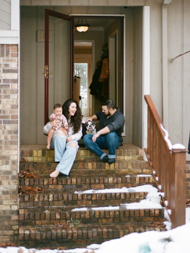 A candid moment of a family sitting together on their front porch steps