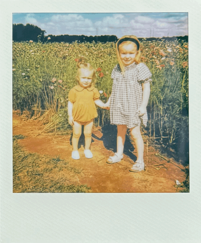 girls holding hands in flower field at hubert family farms by fauna & film
