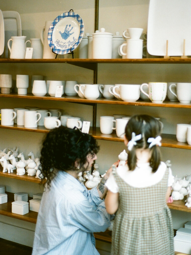 A woman and her daughter choosing pottery pieces to paint at Bisque by The Vessel in Huntsville