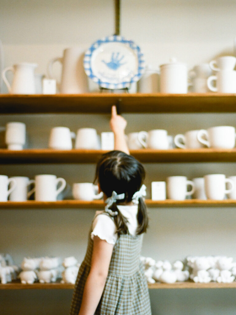 a girl choosing a pottery piece to paint at bisque by the vessel in huntsville